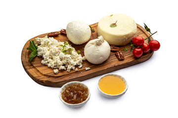 Assorted cheeses on a board with honey and jam