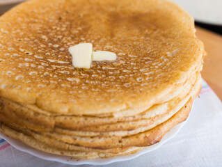 stack of appetizing flour pancakes in the kitchen during cooking