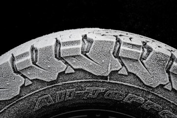 Winter tires with coarse tread, over frozen with ice crystals