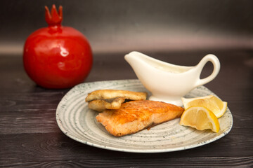 fried breaded fish with white sauce and lemon
