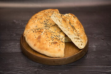 Armenian lavash, on a white wooden background, wooden plate