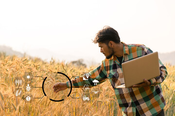 Smart farming concept. Farmer with technology digital tablet on background of wheat field....