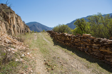 Chuisky tract , the old road .View from the old mountain road, view of the masonry, dirt road and mountain slope.Russia, Altai.
