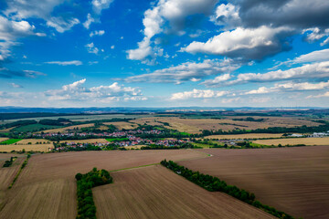 Obraz premium Aer ial view of a German village surrounded by meadows, farmland and forest in Germany.