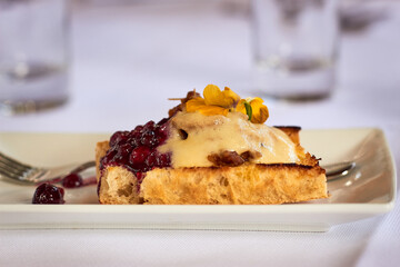 Close up of a delicious colorful snack with red fruit, yellow flower, toast dressed on a plate. Food theme