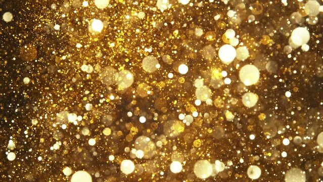 Super slow motion of glittering golden particles. Shallow depth of focus. Filmed on high speed cinema camera, 1000 fps.