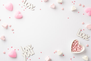 Valentine's Day concept. Top view photo of inscriptions love heart shaped saucer with sprinkles marshmallow and pink candles on isolated white background with copyspace in the middle