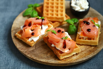 Delicious salmon sandwiches with white cheese on waffles.