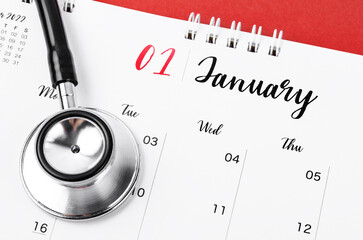 The Stethoscope medical and January 2023 desk calendar on the red background, schedule to check up healthy concepts.