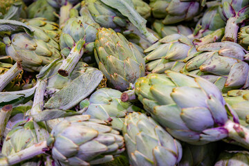 Several heads of artichokes in the market Selective focus.