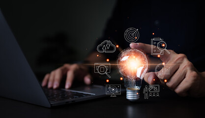 Businessman touching hand creative light bulb with icons global Internet connection on plan...