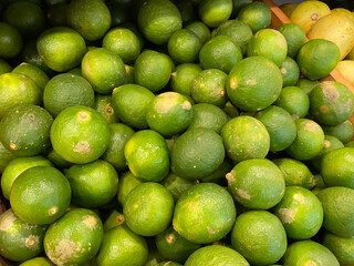 close up view of fresh and healthy lime on the market rack. selective focus of citrus background