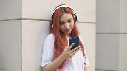 Holiday concept of 4k Resolution. Asian women listening to music in the city. teenage girl fashion.