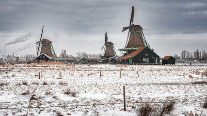 View of traditional Dutch windmills in the small village of Zaanse Schans - 554673411