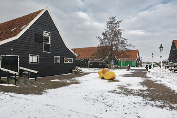 The symbol of the Netherlands is a wooden shoe against the backdrop of a winter landscape in the small village of Zaanse Schans.