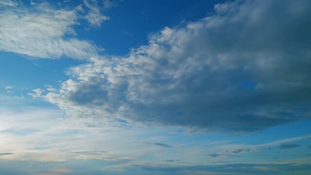 Beautiful epic scenic clouds rolling over sky background backlit by sunset. Horizon, beautiful view landscape. Timelapse.
