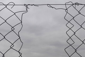 chain link fence with hole damage wire background