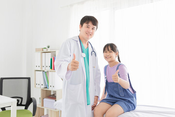 asian doctor and children patient show thumb up sign with hands together, happiness and relationship in hospital, they feeling happy and smile