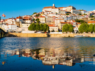 Stunning skyline of Coimbra reflected in Mondego river, Portugal