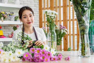 female florists Asians are arranging flowers for customers who come to order them for various ceremonies such as weddings, Valentine's Day or to give to loved ones.