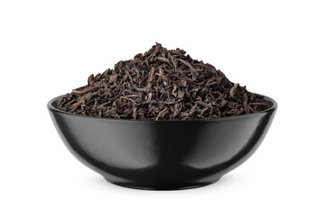 Black dry tea leaves in black bowl isolated on white. Side view.