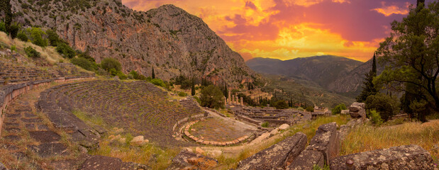 Panoramic view on ancient theater and temple of Apollo with columns in Delphi against the...