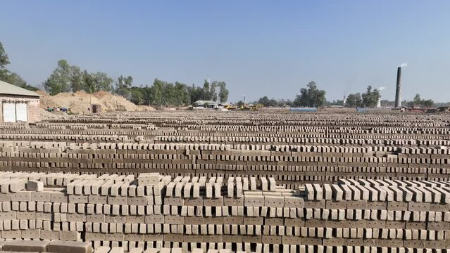 Fly ash bricks in blocks for sale at brick factory - bick field video footage