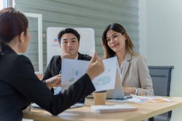 A group of young Asian businessmen Talking and planning work happily and have fun. at the company's office