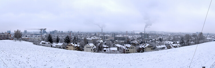 Fototapeta premium Wide angle aerial view over City of Zürich with skyline and snow covered winter landscape on a cloudy late autumn day. Photo taken December 17th, 2022, Zurich, Switzerland.