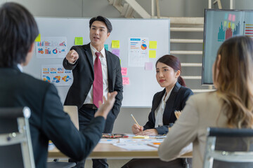A group of young Asian businessmen Talking and planning work happily and have fun. at the company's office