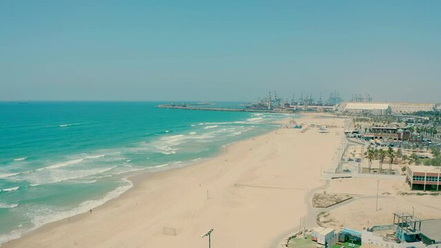 The Mediterranean coast in Israel with a port in the background. Drone video recording of the coastal strip in Ashdod.