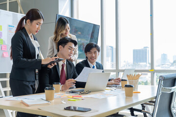 A group of young Asian businessmen Talking and planning work happily and have fun. at the company's office