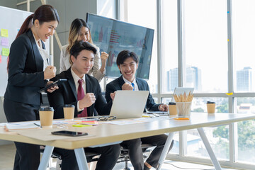 A group of young Asian businessmen Talking and planning work happily and have fun. at the company's office