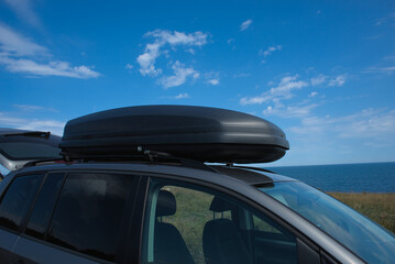 Fototapeta na wymiar Car roof box. Box for transporting additional things on the roof of the car