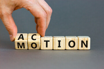 Action or motion symbol. Concept word Motion and Action on wooden cubes. Businessman hand. Beautiful grey table grey background. Business and action or motion concept. Copy space.