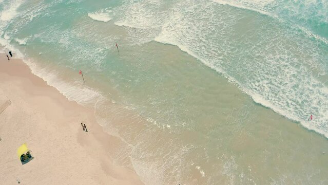 Video shooting from a drone of the beach in Ashdod in Israel. Few people enjoy the beach at noon.