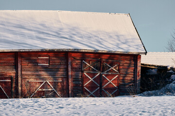 A red barn of a winter evening at Toten, Norway, in December.