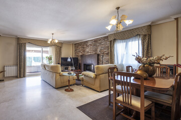 Living room with space for a wooden dining table with matching chairs and large windows along the walls