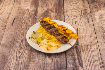 chicken or beef skewer cooked on a vertical rotisserie, usually eaten with a flatbread such as pide...