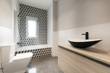 Contemporary designer bathroom with teardrop shaped black porcelain toilets with shower column and black faucets and 3d graphic design tiles