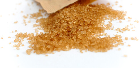 heap of brown sugar on white background