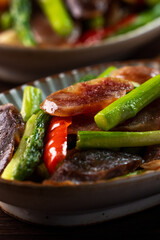 Delicious spicy homemade stir-fried Chinese smoked sausage with asparagus.