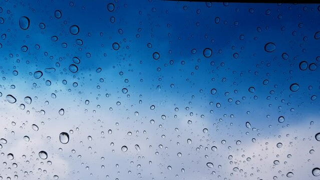 Water droplets perspective through glass surface against blue sky good