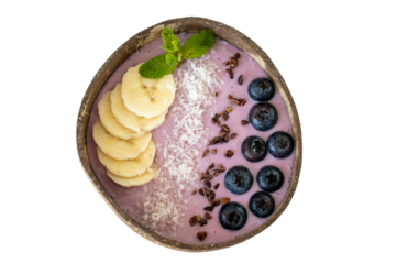 A tasty, healthy breakfast. Smoothie Bowl. Blueberry yogurt smoothie with banana and coconut. Top view on clear background png	
