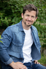 portrait of smiling young man in park