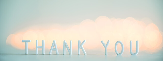 The words THANK YOU on the background of bokeh lights