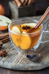 A tea cup filled with homemade mulled apple cider, ready for drinking.