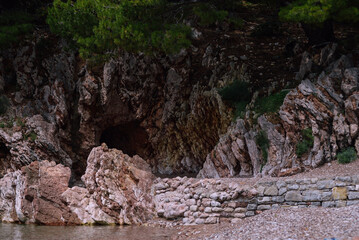 Colorful cave in the rock layered structure. The ocher color of the rock.
