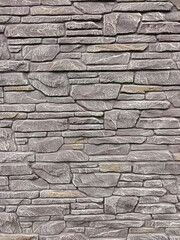 A stone wall of bricks of various shapes on the whole background