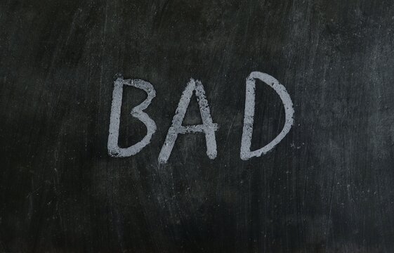 Bad Word with Written on Blackboard with White Chalk in Horizontal Orientation
